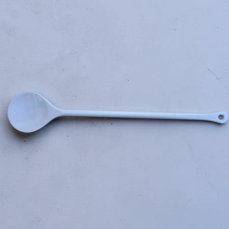Short Plastic Stirring Spoon on a flat surface, showcasing its lightweight design and comfortable length of 31cm.